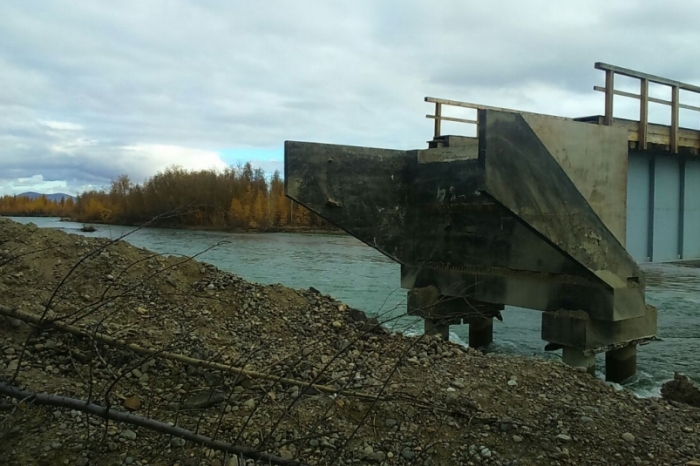 Спасатели помогают людям перебраться через разрушенный мост в Якутии